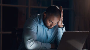 worried man at computer