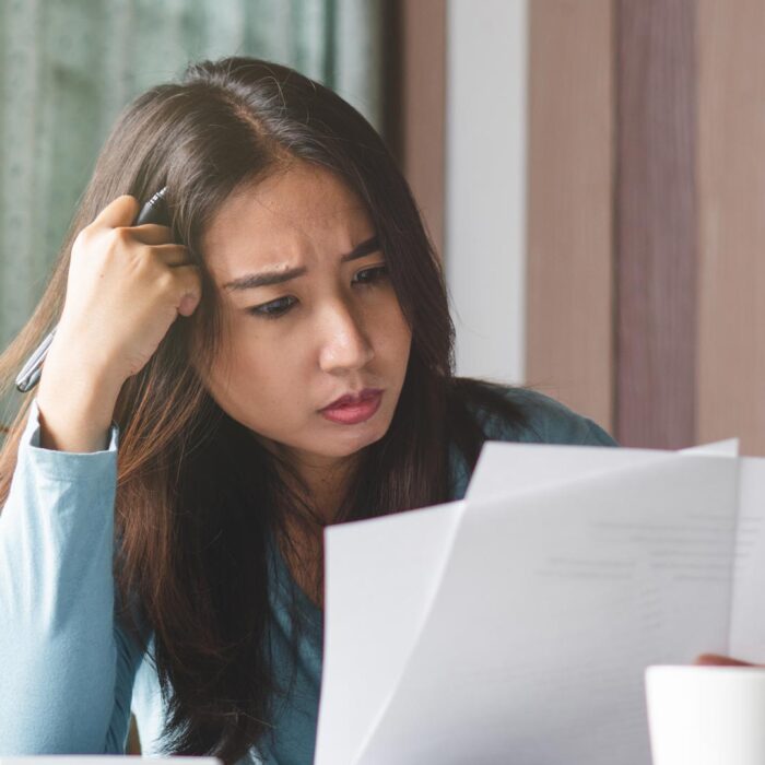 worried woman looking at documents