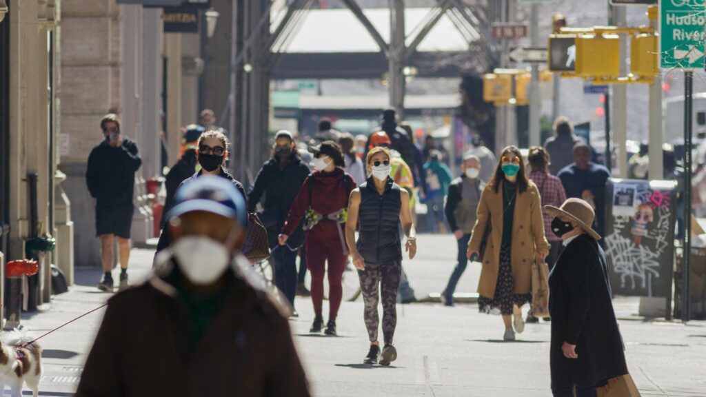 people on sidewalk with masks