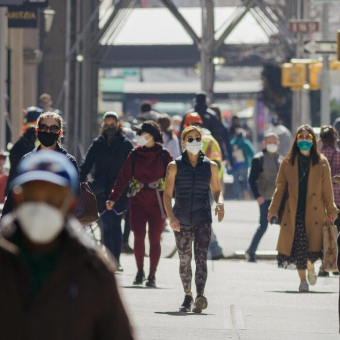 people on sidewalk with masks